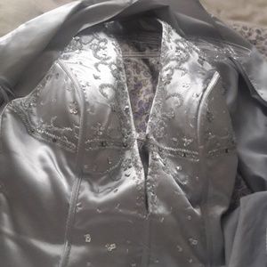 A sliver gown that has intricate beading